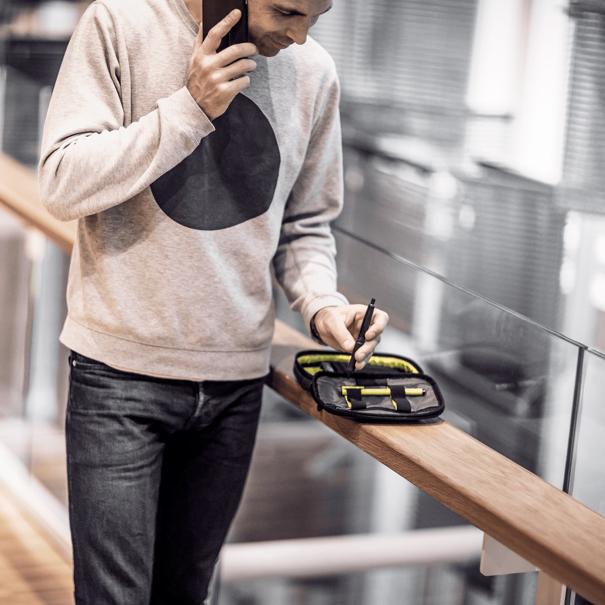 business man with work case on a cellphone
