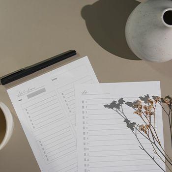 two pieces of list paper and a pen