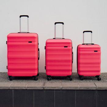Luna Air Suitcases in Hot Pink - three different sizes lined up in height order