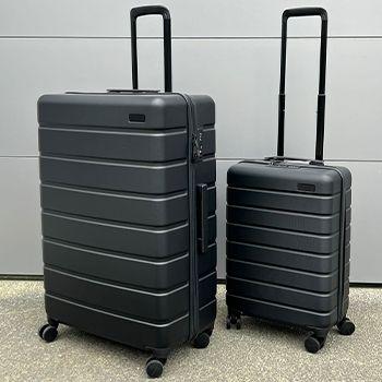 A large and Small Explorer Arlo Suitcase on the concrete