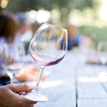 Person holding wine glass at a table
