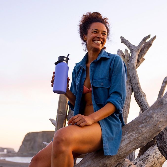 Lupine Hydro Flask bottle held by a Mother at sun at sunset