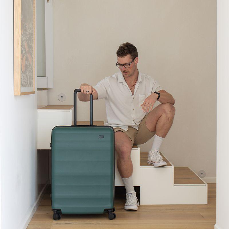 Large Luna-Air in Forest Green, Man sitting with it on a staircase 