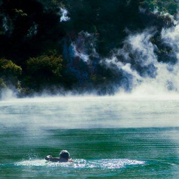 person swimming at a swimming hole