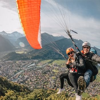 Woman and man tandem skydiving 