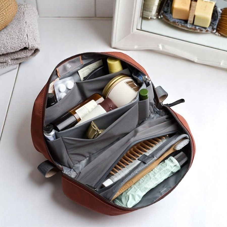 Bellroy Toiletry Kit Plus laid open with toiletry products organised inside. 