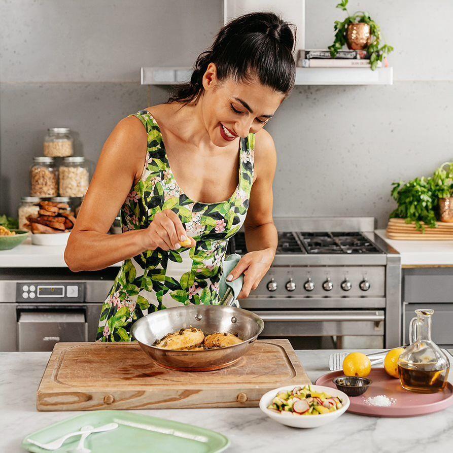 cook in kitchen seasoning a meal