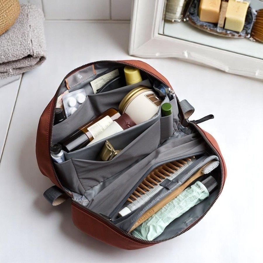 Bellroy Toiletry Kit Plus laid open with toiletry products organised inside. 