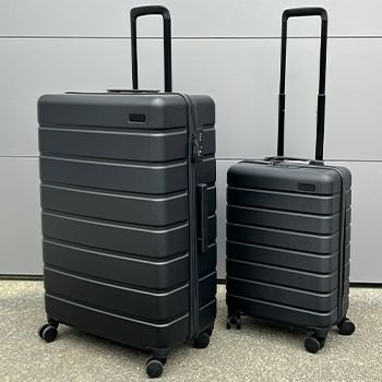 A large and Small Explorer Arlo Suitcase on the concrete