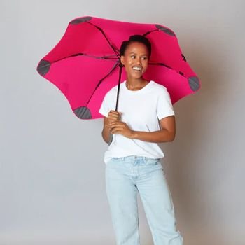 Women holding pink blunt metro umbrella