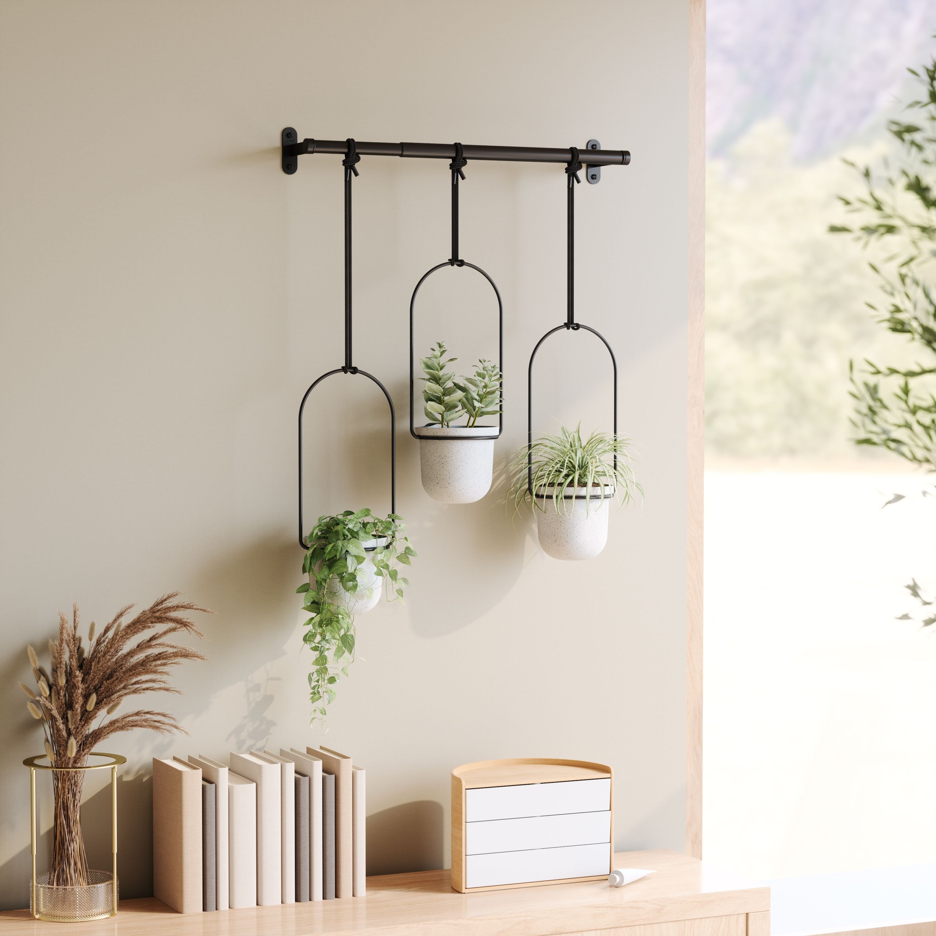tri hanging planter above a table with books and a jewellery box
