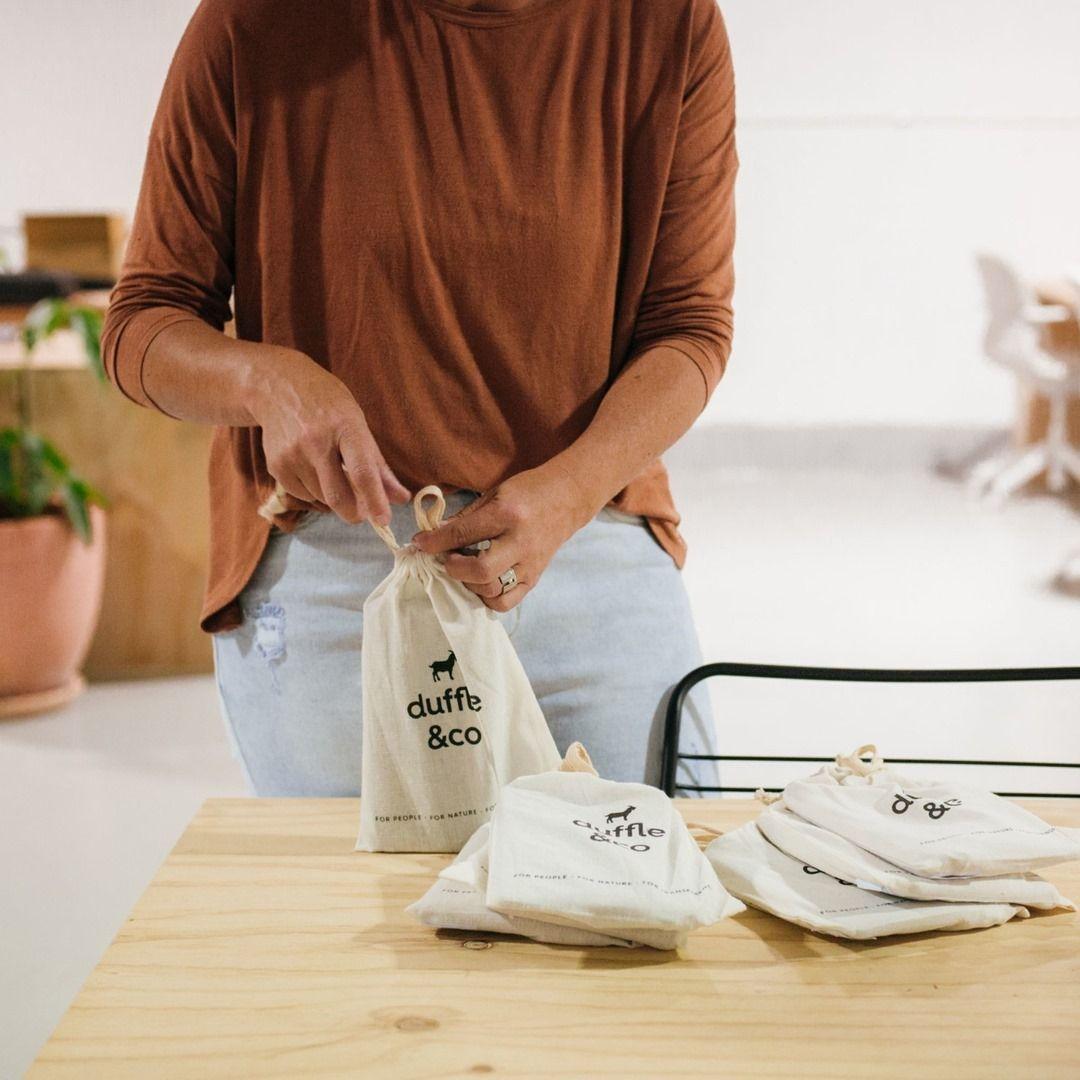 Woman packing with Duffle&Co cotton cover bags