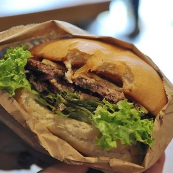 Beef burger from Fergburger with a bite taken out of it