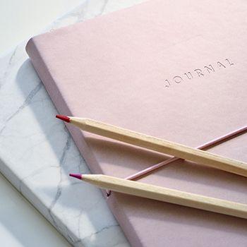 Pink journal and two colouring pencils