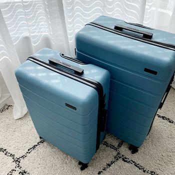 A medium and large arlo suitcase set in ocean