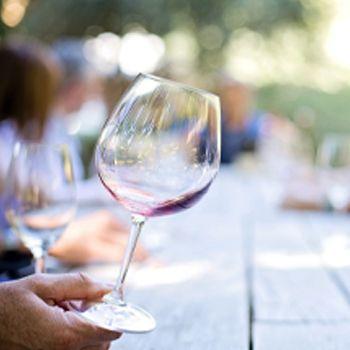Person holding wine glass at a table