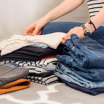 Woman folding clothes into piles