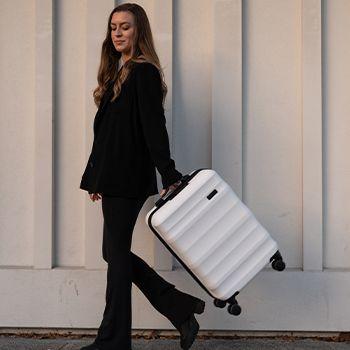woman with a white carry-on suitcase
