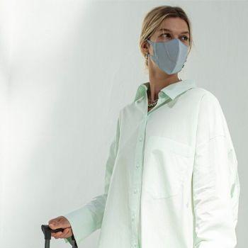 Women in a green shirt wearing an airinum face mask
