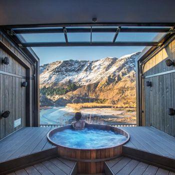 Women soaking in Onsen hot pools with a view of the mountains